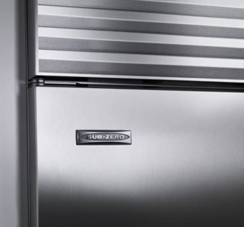 Sub-Zero, Inc.: Side-by-Side Built-In Refrigeration Detail view of the stainless steel finish and the Sub-Zero logo