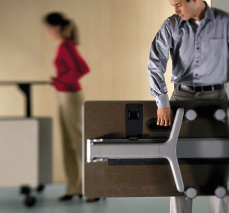 Allsteel Inc.: Get Set Table Image showing a user carrying a completely folded get set chair