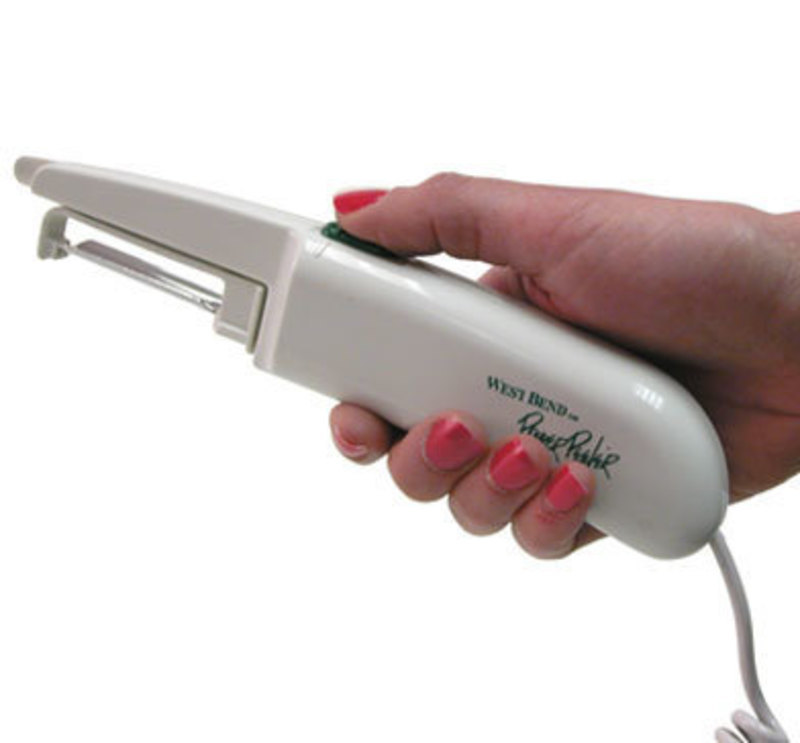 Side view of the Power Peeler in a user's hand