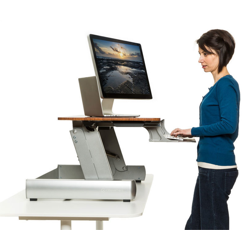 Side view of the InMovement desktop with a person using it on a desk