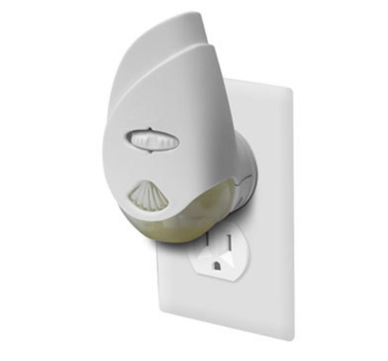Three quarters view of the glade scented oil plugin plugged into a wall outlet